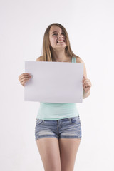 cheerful woman holding a white blank banner