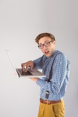 Geeky businessman using his laptop