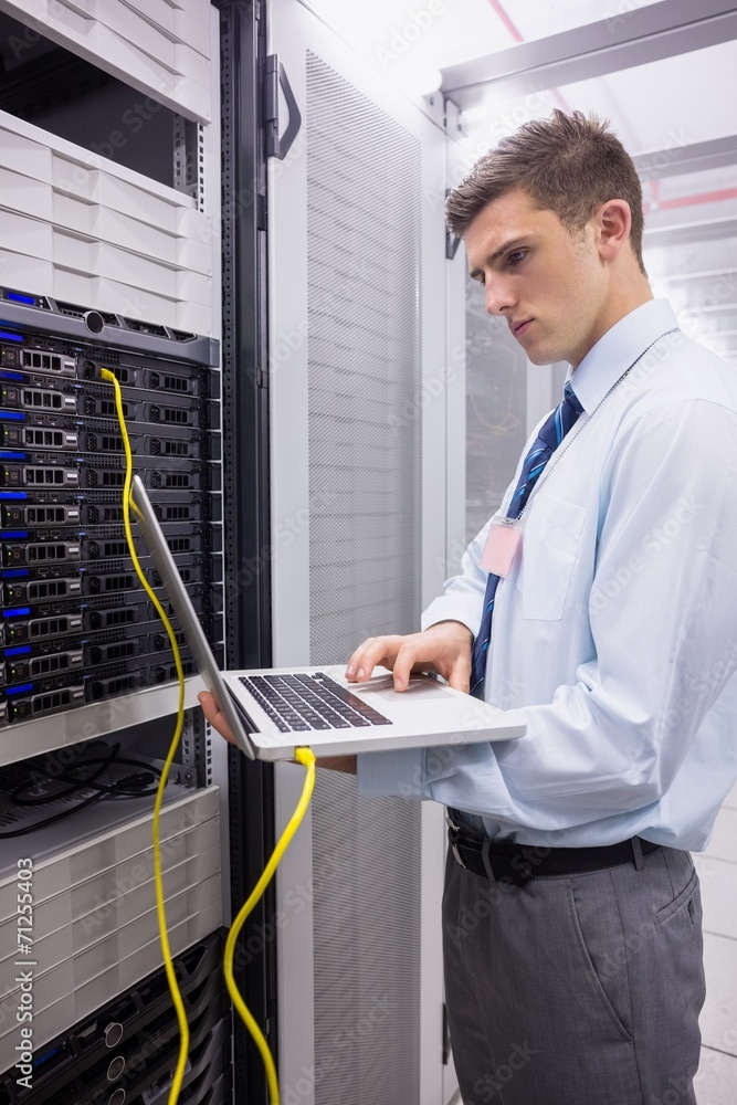 Aufkleber Technician using laptop while analysing server