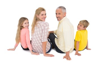 Obraz premium Happy family sitting and smiling