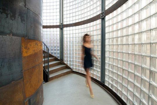 Blurred woman walking inside Be Towers bar in Budrio, Bologna, I