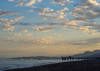 Sunrise on the summer beach with blue hills on the horizon