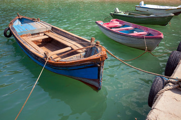Fototapeta na wymiar Old small wooden fishing boats moored in small Bulgarian town