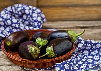 fresh, organic eggplants in a wattled basket