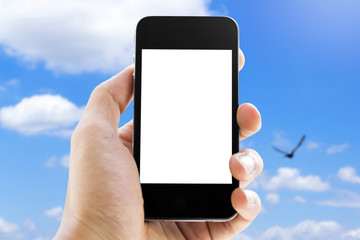 hand holding phone on sky background