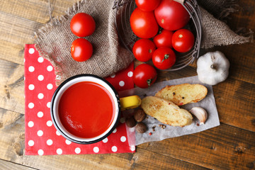Homemade tomato juice in color mug, toasts and fresh tomatoes