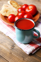 Homemade tomato juice in color mug, toasts and fresh tomatoes