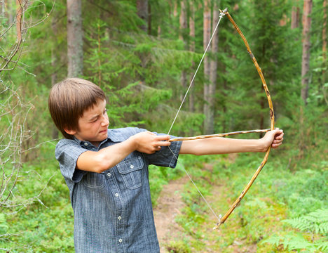 Kid with homemade bow and arrow