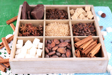 Wooden box with set of coffee and cocoa beans, sugar cubes,