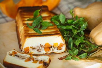Cottage cheese casserole with slices of pumpkin and nuts
