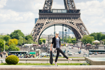 Fashion young blonde woman portrait in front of the Eiffel Tower