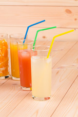 Various juices on wooden table.