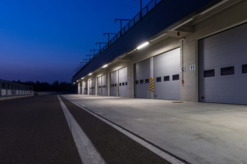 Garages in race circuit. Night time. - 71262440