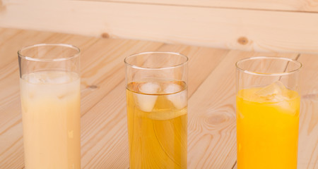 Various fresh juice on wooden table.