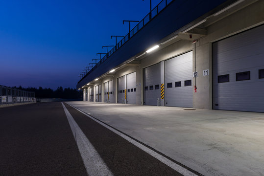 Garages in race circuit. Night time.
