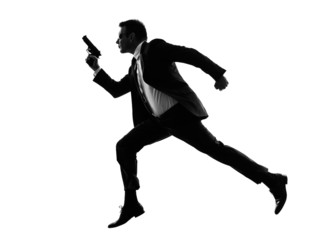 Fototapeta na wymiar man with handgun running silhouette