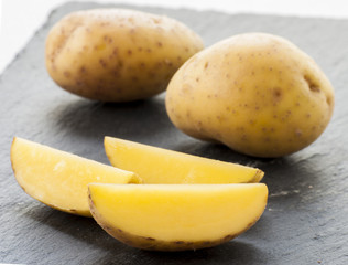 potatoes cut on black background close up