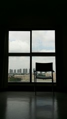 Chair near window with city view.