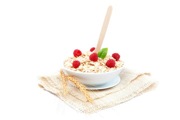 Fresh raspberry and Oatmeal flakes on white background. Healthy
