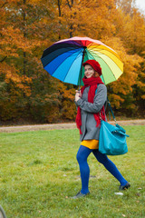 Cheerful woman enjoying autumn day in park