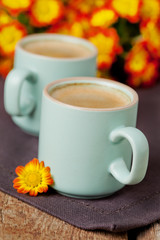 Cup of cofee with bright autumn flowers