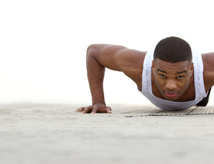 Young black man doing push ups outdoors