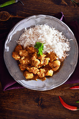 overhead view of indian chicken curry on plate with copyspace