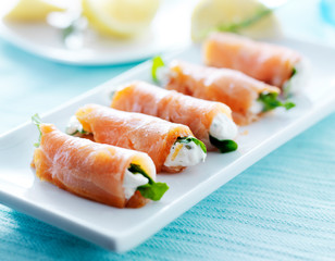 smoked salmon and arugul warp with cream cheese on platter