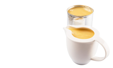 Condensed milk in tin can and milk pitcher