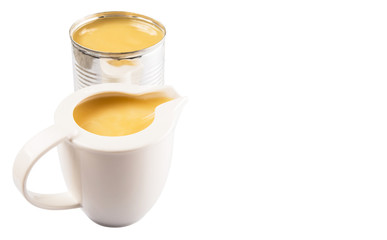 Condensed milk in tin can and milk pitcher