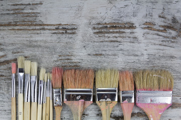 Set of paintbrushes in a wood background
