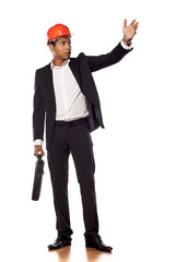 Angry african businessman with a helmet showing with his hand