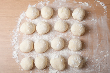 Fototapeta na wymiar Small balls of dough with flour for pizza or cakes and scones. S