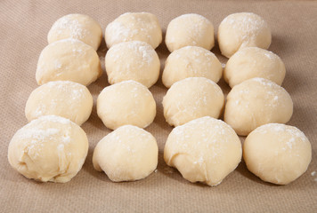 Fototapeta na wymiar Small balls of dough with flour for pizza or cakes and scones ly