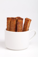 long croutons in a white cup