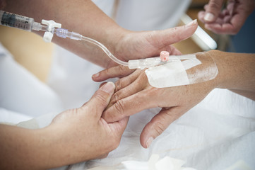Nurses preparing an iv for the patient.