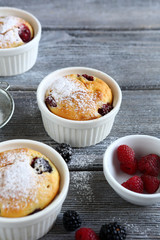 berry muffins on wooden background