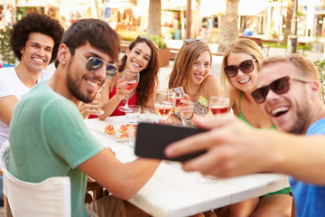 Group Of Friends Taking Selfie During Lunch Outdoors