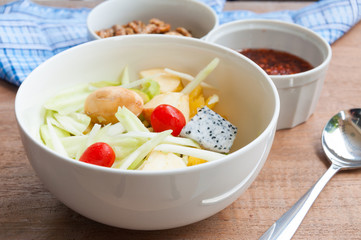 Delicious fruits salad in plate on table close-up