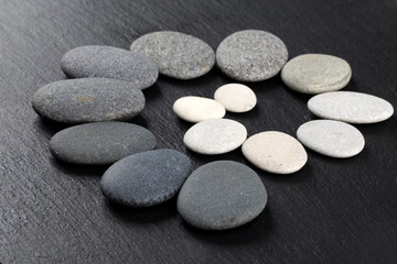 Black and white stones on rock background