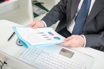 Businessman checking financial graphs