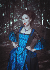 Beautiful woman vampire in medieval dress