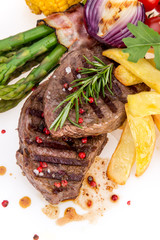 Tasty beef steaks on white background