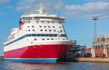 Fototapeta na wymiar Red and white passenger ferry is moored in port