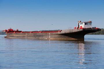 Big cargo barge is anchored on the Danube between Bulgaria and R