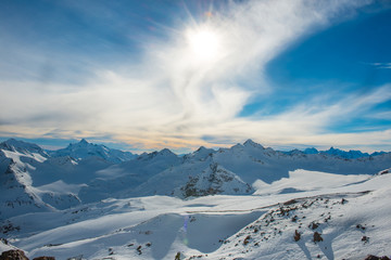 Snowy blue mountains in clouds