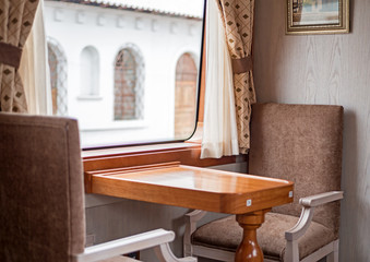 Fototapeta na wymiar Chairs and table inside a train wagon