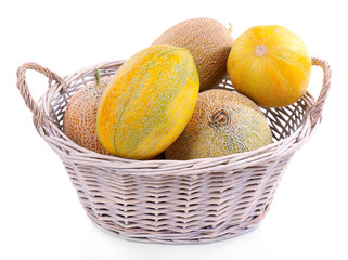 Melons in basket isolated on white