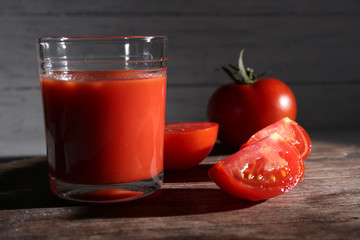 glass of tomato juice with spices and fresh tomatoes