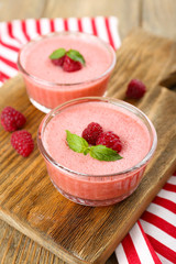 Delicious berry mousse in bowls on table close-up
